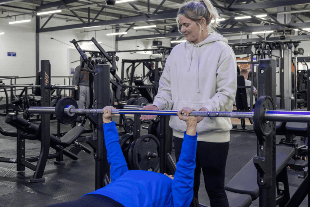People that have met through Horizon Buddies at Havant gym. One doing a chest press, one helping.
