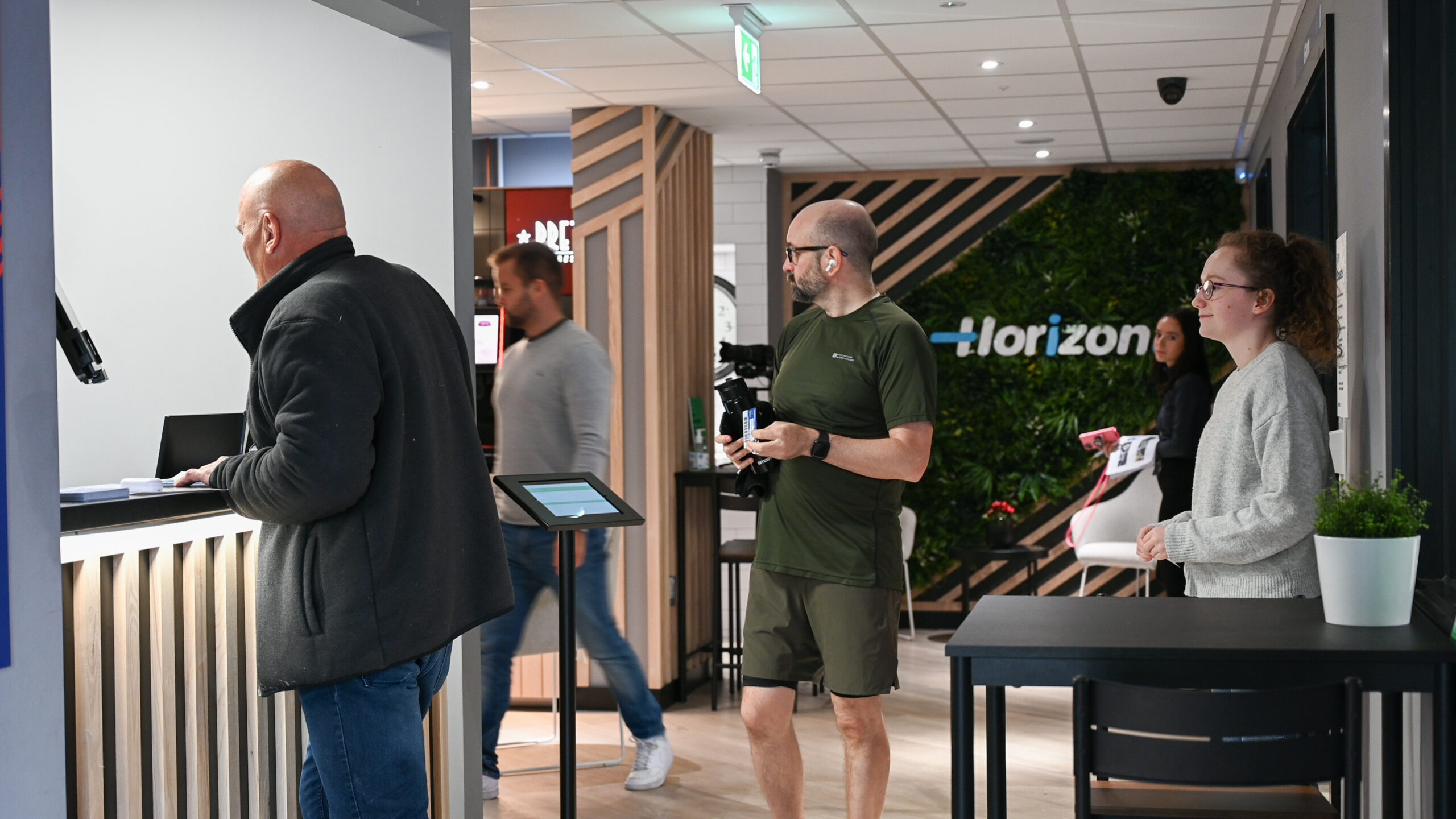 People interacting in a modern reception area.