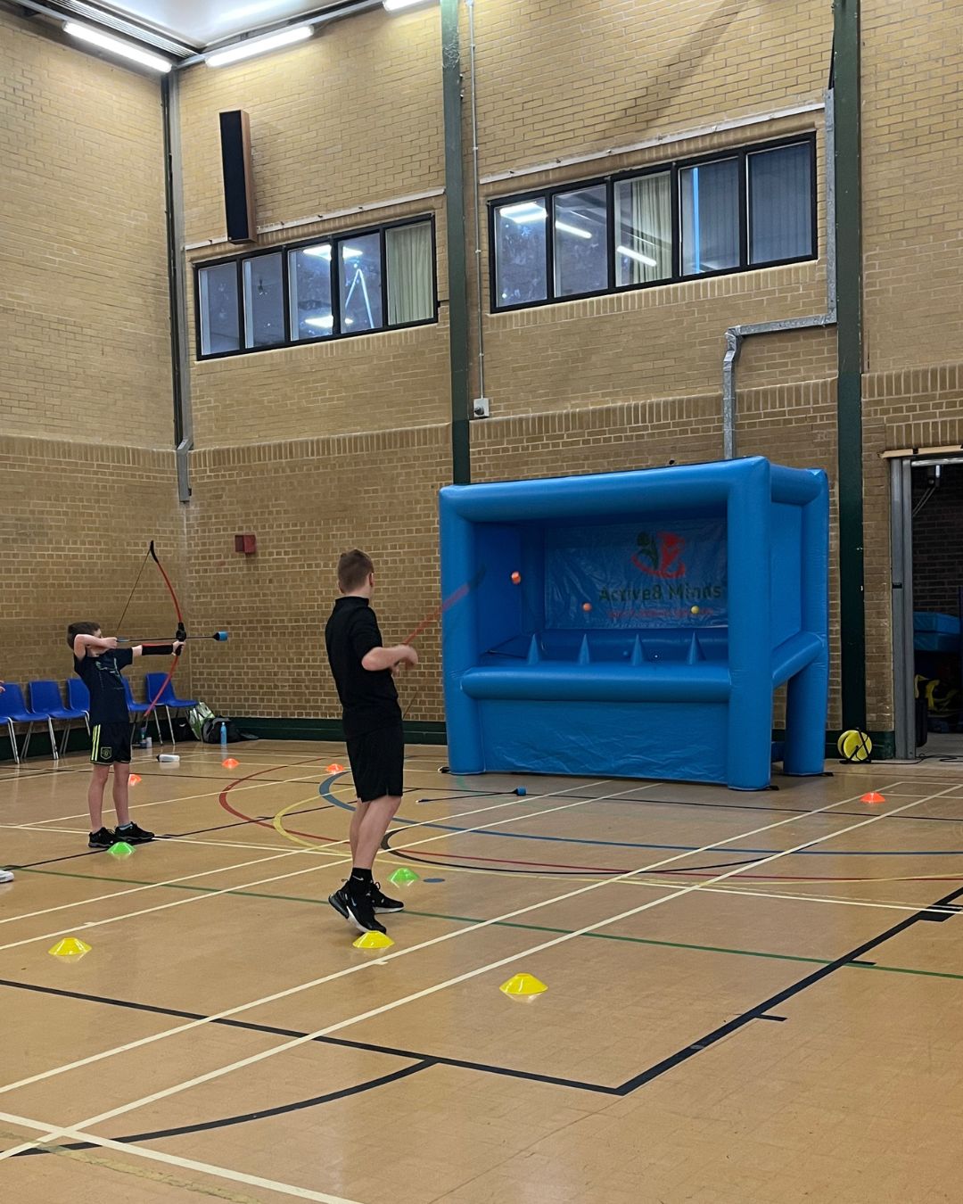 Children playing sports in a gymnasium family fitness