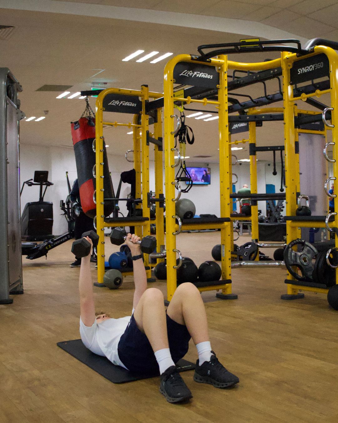 Young person exercising with dumbbells.