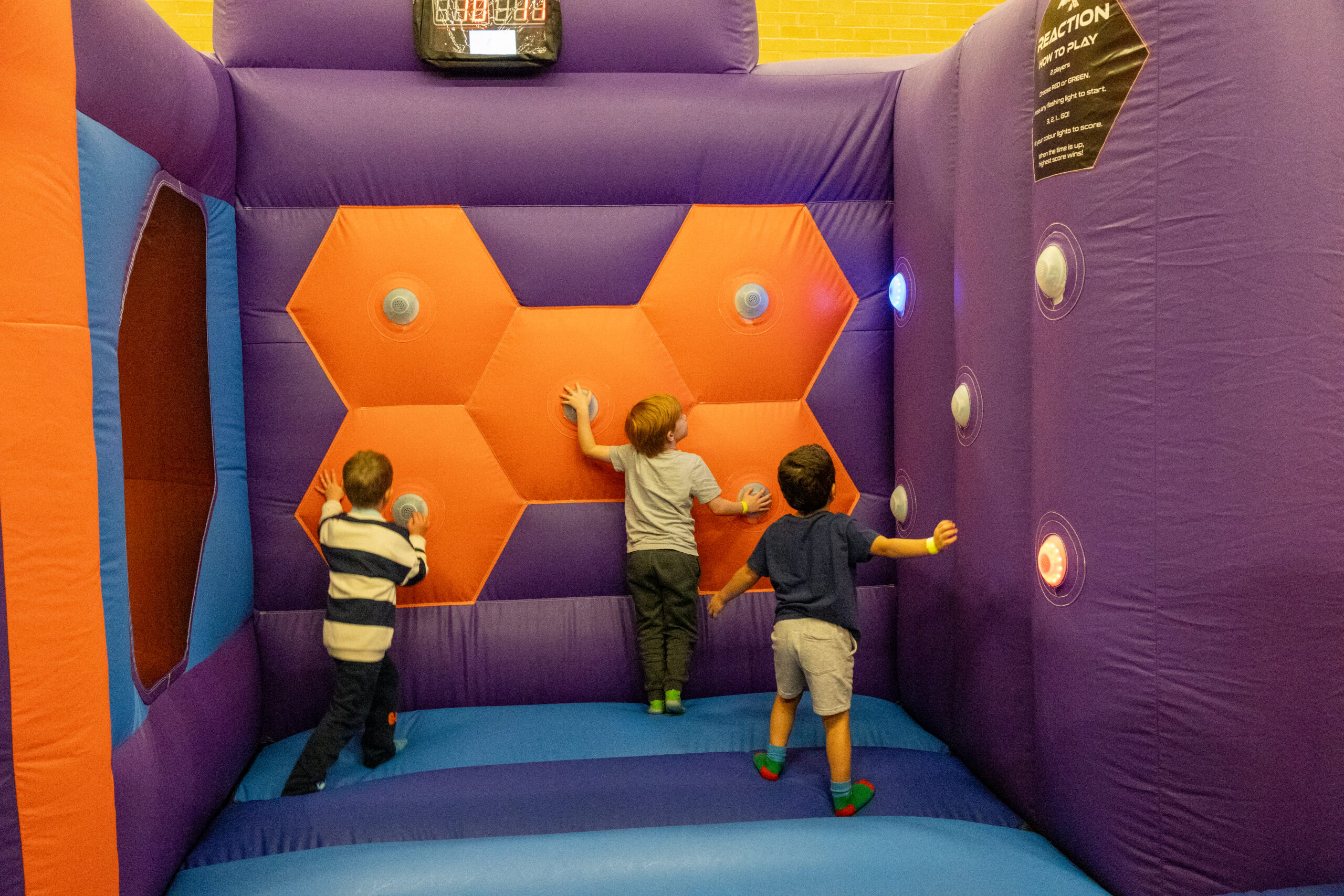 Children playing on inflatable climbing wall