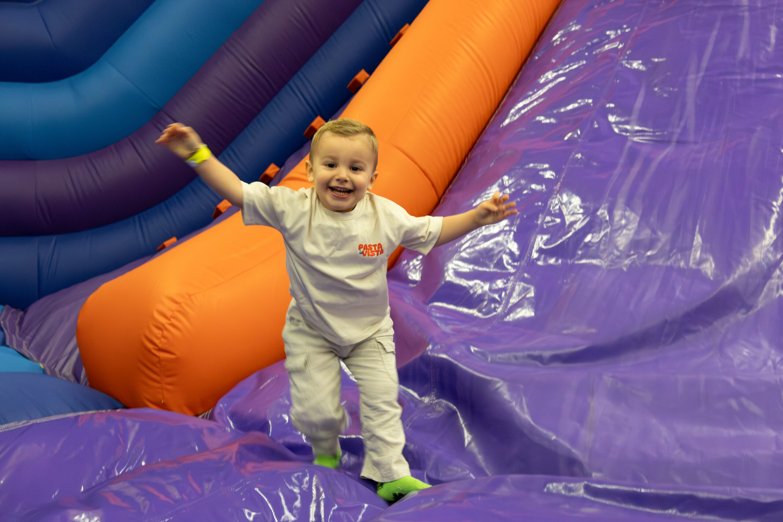 Child playing on inflatable slide.