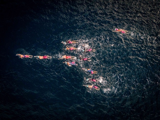 Swimmers competing in open water race.