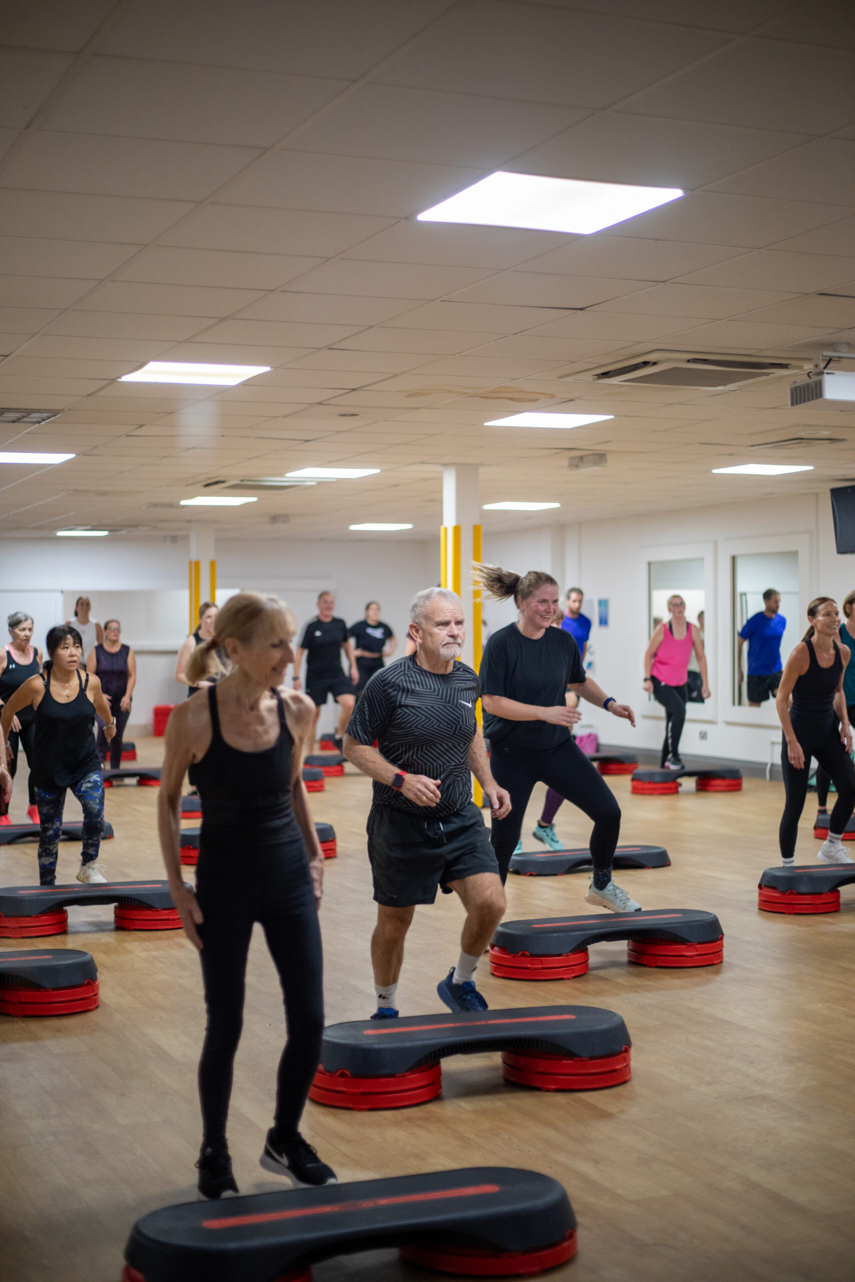Group exercising on fitness platforms staying active